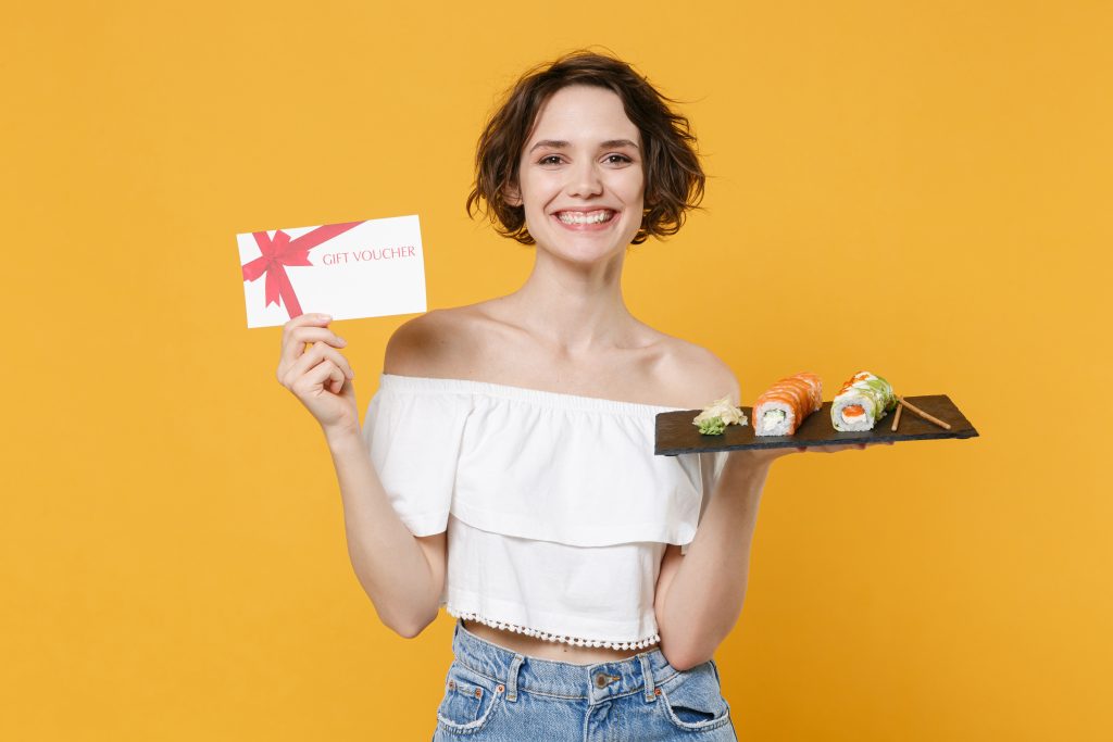 A girl holding a food voucher gift