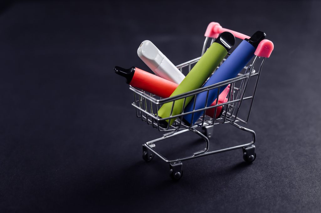 Disposable vapes in a shopping cart on a black background.  Get the latest disposable pods at SG Vapehub!