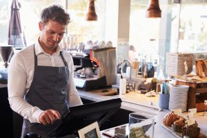 An employee is using POS System table in a restaurant